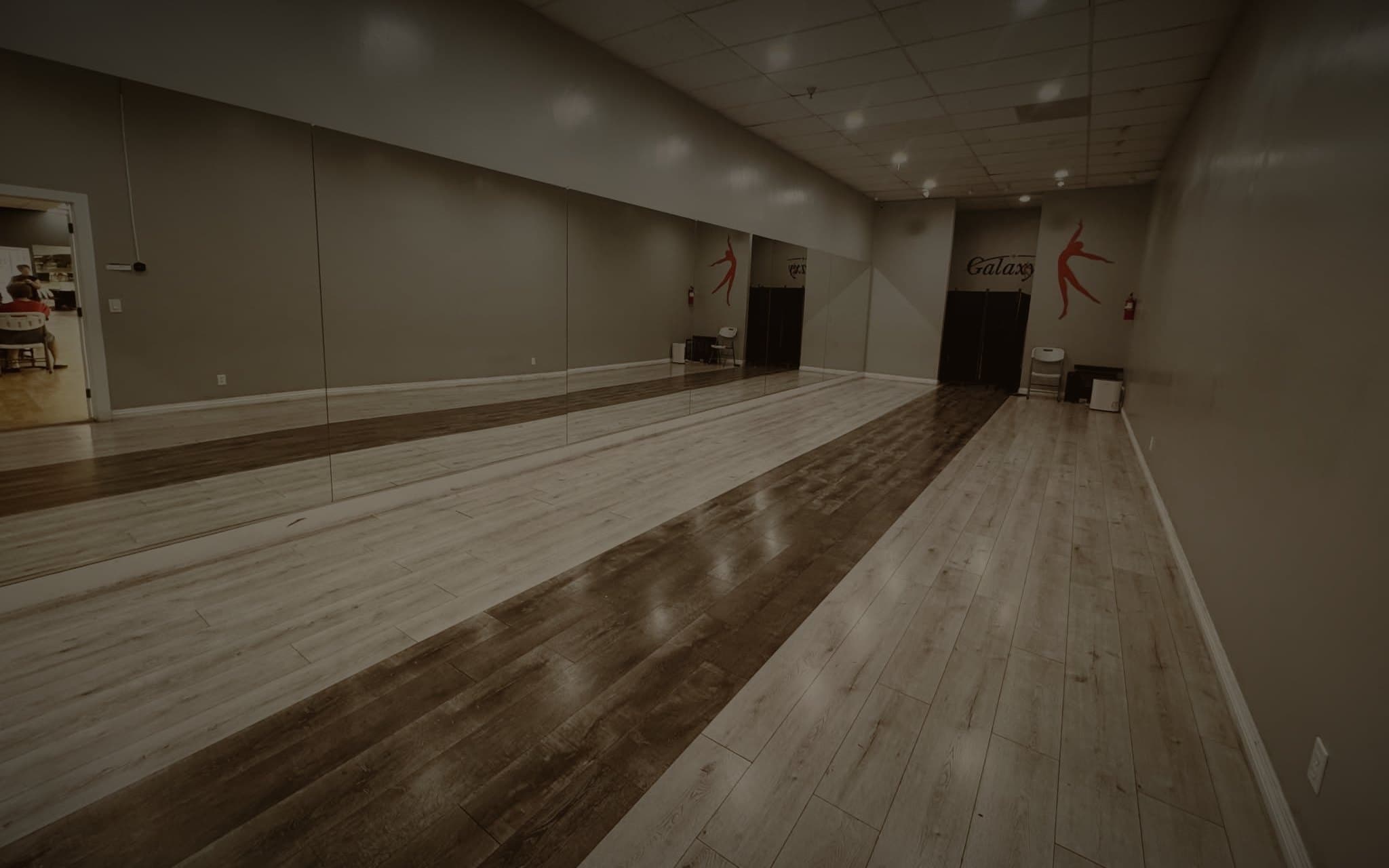 The Fallaway Room, a long floor with a mirrored wall and the Galaxy dancer painted at the far end