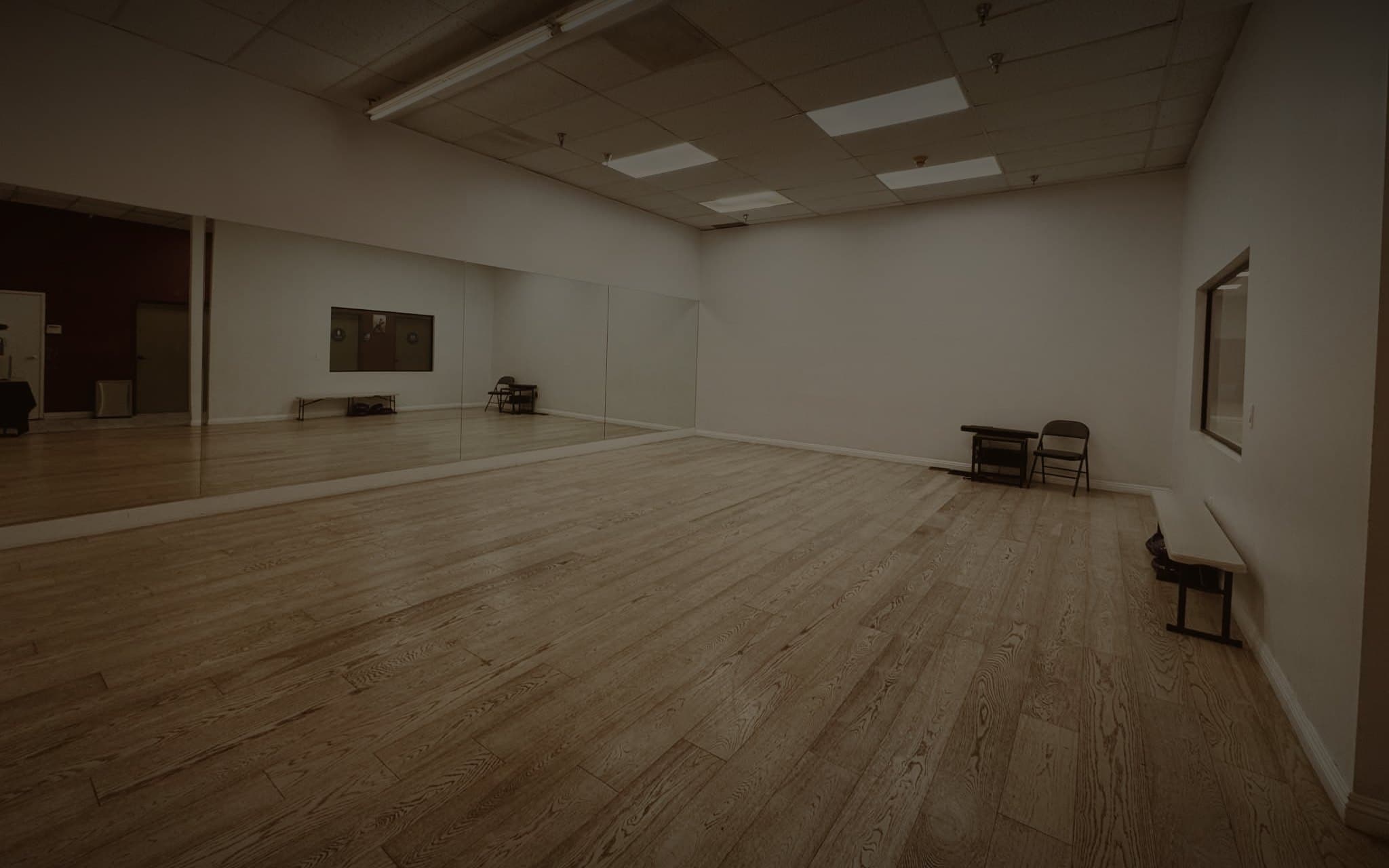 The Hip-Twist Room, an open wooden floor with a full mirrored wall